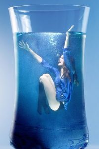 Woman in a glass of water